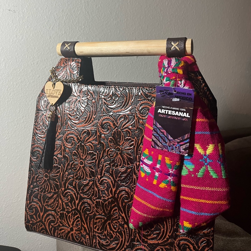 Real leather with wood handles .made by Mexican artisans . Dark brown